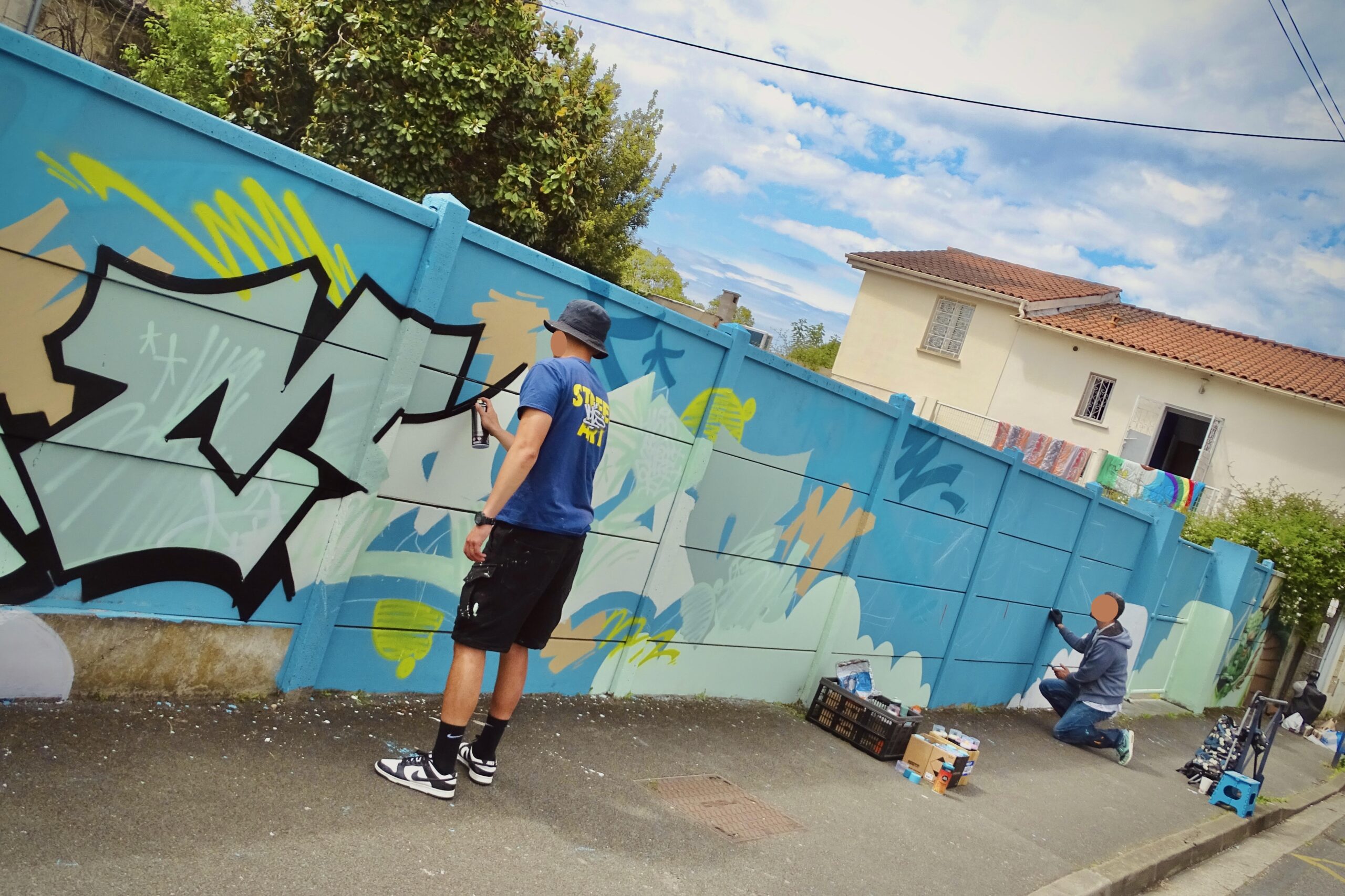 Artistes MEL20 et Pops traçant contours et esquisse de lettrage graffiti à Cenon